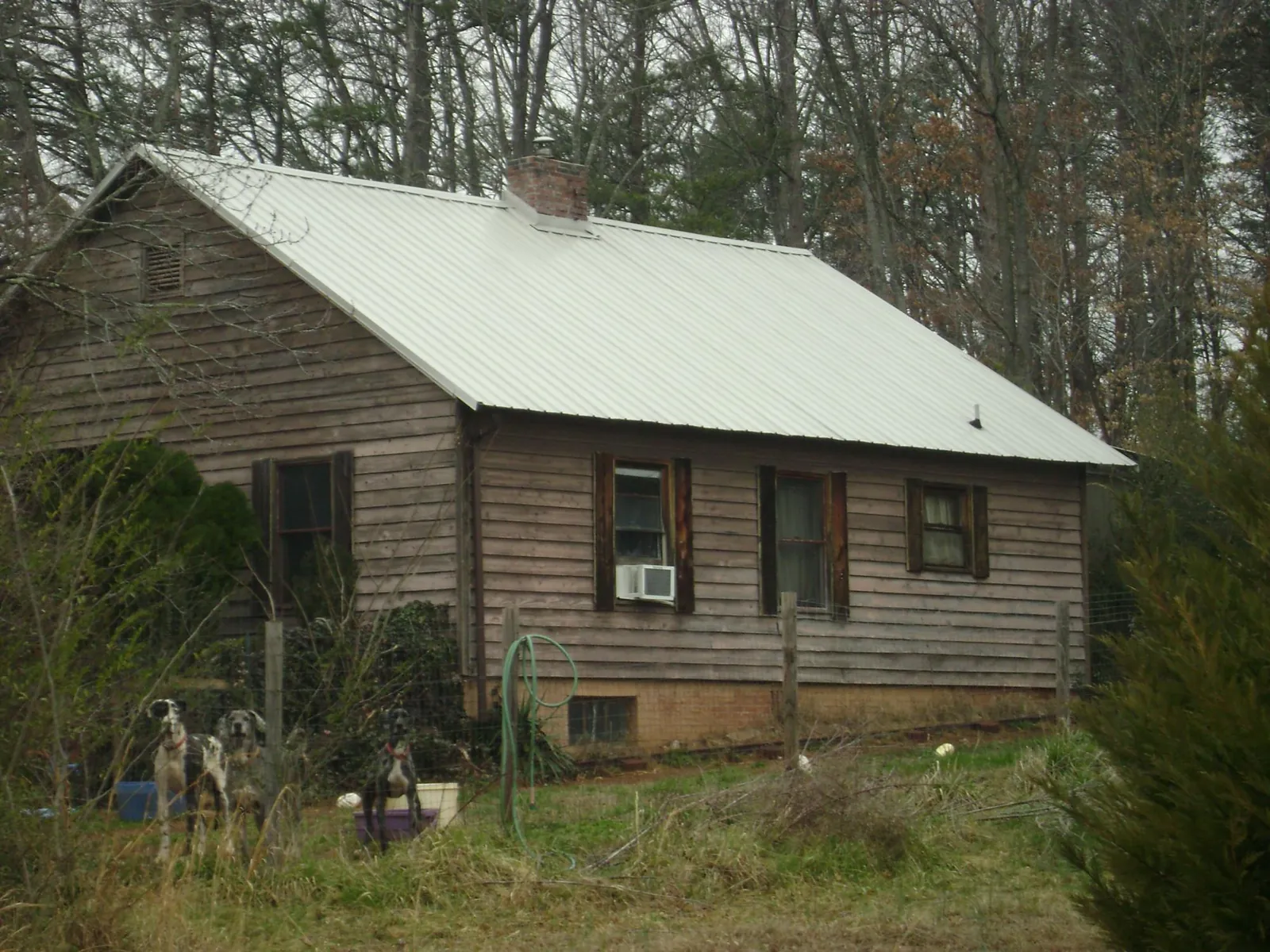 White metal roof on an old wood sided farmhouse, from a Metal Roof Installation job in Elizabethtown